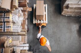 young-man-working-warehouse-with-boxes-min