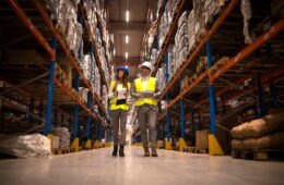 managers-walking-through-large-warehouse-controlling-goods-distribution(1)-min